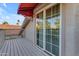 Exterior view of the balcony featuring a sliding door, an awning, and a view of the neighborhood at 6841 S Roosevelt St, Tempe, AZ 85283