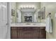 Bathroom features a double vanity with dark cabinets, light counter tops, and decorative lighting at 6841 S Roosevelt St, Tempe, AZ 85283