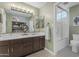 Bathroom features a double vanity with a tiled shower and decorative light fixture at 6841 S Roosevelt St, Tempe, AZ 85283