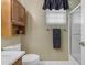 This bathroom features a wood cabinet and white toilet and sink at 6841 S Roosevelt St, Tempe, AZ 85283