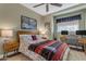 Bedroom with a ceiling fan, neutral paint, a desk, and two night stands at 6841 S Roosevelt St, Tempe, AZ 85283
