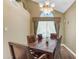 Cozy dining area featuring a wooden table, upholstered chairs, and natural light at 6841 S Roosevelt St, Tempe, AZ 85283