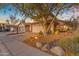 Charming two-story home with a tile roof, attached garage, and a desert-landscaped front yard with rock and cactus at 6841 S Roosevelt St, Tempe, AZ 85283