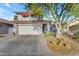 Charming two-story home with a tile roof, attached garage, and a desert-landscaped front yard at 6841 S Roosevelt St, Tempe, AZ 85283