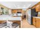 Spacious kitchen with stainless appliances, a breakfast bar, and wood cabinets at 6841 S Roosevelt St, Tempe, AZ 85283