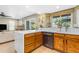 Bright kitchen featuring white countertops, stainless steel appliances, and backyard views at 6841 S Roosevelt St, Tempe, AZ 85283