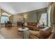 Inviting living room featuring a leather sofa, hardwood floors, and a dining area at 6841 S Roosevelt St, Tempe, AZ 85283