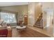 Inviting living room featuring a staircase, leather furniture, and stylish decor at 6841 S Roosevelt St, Tempe, AZ 85283