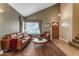 Warm living room showcasing a vaulted ceiling, leather sofa, and decorative window treatments at 6841 S Roosevelt St, Tempe, AZ 85283