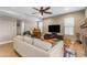 Comfortable living room boasts a ceiling fan, tan sofa, tile floor, and several windows for natural light at 6841 S Roosevelt St, Tempe, AZ 85283