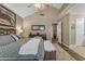 Bright main bedroom features a high ceiling, neutral colors, a ceiling fan, and an en-suite bathroom at 6841 S Roosevelt St, Tempe, AZ 85283