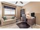 Well-lit home office boasts a comfy sofa, sleek desk, and built-in shelving at 6841 S Roosevelt St, Tempe, AZ 85283