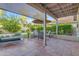Relaxing backyard patio with cozy seating, sun umbrella, and lush landscaping at 6841 S Roosevelt St, Tempe, AZ 85283