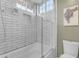 Bathroom shower with white subway tile, a glass door, and a view of the bathroom at 6841 S Roosevelt St, Tempe, AZ 85283