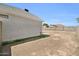 Side view of the home showcasing the stucco exterior, roof, and large backyard at 7114 W Yucca St, Peoria, AZ 85345