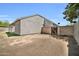 Side view of home with stucco exterior, covered patio, brick wall, and grass at 7114 W Yucca St, Peoria, AZ 85345