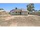 Back view of the home featuring stucco exterior, covered patio, and spacious backyard at 7114 W Yucca St, Peoria, AZ 85345
