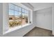 Bright bedroom with large window, neutral carpet, white walls, and a closet with hanging rack at 7114 W Yucca St, Peoria, AZ 85345