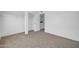 Bedroom featuring white walls, neutral carpet, a closet, and a view of neighborhood at 7114 W Yucca St, Peoria, AZ 85345