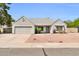 Charming single-story home featuring a well-maintained gray exterior, desert landscaping, and an attached two-car garage at 7114 W Yucca St, Peoria, AZ 85345