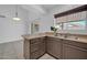 Open kitchen showcasing countertop, stainless steel sink, tile flooring, and ample natural light at 7114 W Yucca St, Peoria, AZ 85345