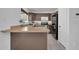 Open concept kitchen featuring stainless steel appliances and a breakfast bar at 7114 W Yucca St, Peoria, AZ 85345