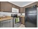 Well-equipped kitchen featuring stainless steel appliances, oak cabinets, and tile flooring at 7114 W Yucca St, Peoria, AZ 85345