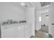 Laundry room features a white washer and dryer, tile flooring, and white walls at 7114 W Yucca St, Peoria, AZ 85345