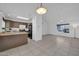 Open floor plan combining the living room and kitchen with neutral tile flooring at 7114 W Yucca St, Peoria, AZ 85345