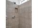Shower featuring beige tiled walls and a built in shelf at 7114 W Yucca St, Peoria, AZ 85345