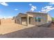 The home's backyard has desert landscaping and a covered patio, perfect for relaxing outdoors at 716 W Blue Ridge Dr, San Tan Valley, AZ 85140