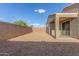 A large backyard features rock landscaping, block wall fencing and covered patio space at 716 W Blue Ridge Dr, San Tan Valley, AZ 85140
