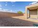 Backyard with covered patio and block fencing for privacy at 716 W Blue Ridge Dr, San Tan Valley, AZ 85140
