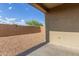 The backyard features a tan stucco wall, a gravel landscape and a covered patio at 716 W Blue Ridge Dr, San Tan Valley, AZ 85140