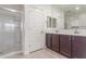 Bathroom featuring glass shower, double sink vanity with dark cabinets, tile floors, and white walls at 716 W Blue Ridge Dr, San Tan Valley, AZ 85140