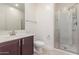 Bathroom features a vanity with a dark wood cabinet and walk in shower with glass doors at 716 W Blue Ridge Dr, San Tan Valley, AZ 85140