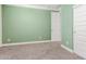 Light green bedroom with carpet, white trim, and neutral walls provides a calming and comfortable space at 716 W Blue Ridge Dr, San Tan Valley, AZ 85140