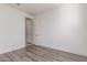 Bright bedroom with wood-look flooring and a white door, creating a simple and clean space at 716 W Blue Ridge Dr, San Tan Valley, AZ 85140