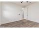 Empty bedroom with hardwood floors, ceiling fan, and a closet; freshly painted at 716 W Blue Ridge Dr, San Tan Valley, AZ 85140