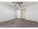 Bright bedroom with neutral carpet, a ceiling fan, and an ensuite bathroom at 716 W Blue Ridge Dr, San Tan Valley, AZ 85140