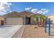 Well-maintained front exterior features desert landscaping and a two car garage at 716 W Blue Ridge Dr, San Tan Valley, AZ 85140