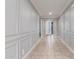 Hallway with custom wainscotting and trim leads to bedrooms and living areas at 716 W Blue Ridge Dr, San Tan Valley, AZ 85140