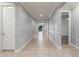 Long hallway with neutral tile flooring, paneled walls and white doors adds architectural detail to this home at 716 W Blue Ridge Dr, San Tan Valley, AZ 85140