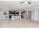 View of large kitchen and living space with stainless appliances, dark wood cabinets, granite counters, recessed lighting, and tile floors at 716 W Blue Ridge Dr, San Tan Valley, AZ 85140