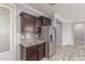 Kitchen with stainless steel appliances, dark wood cabinets and granite counters at 716 W Blue Ridge Dr, San Tan Valley, AZ 85140