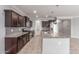 Kitchen featuring stainless appliances, dark wood cabinets, granite counters, recessed lighting, pendant lights, and tile floors at 716 W Blue Ridge Dr, San Tan Valley, AZ 85140