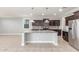 Kitchen featuring stainless appliances, dark wood cabinets, granite counters, recessed lighting, pendant lights, and tile floors at 716 W Blue Ridge Dr, San Tan Valley, AZ 85140
