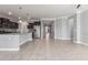 Open concept living space adjacent to kitchen features tile floors and neutral colored walls at 716 W Blue Ridge Dr, San Tan Valley, AZ 85140