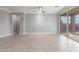 Spacious living room with tile flooring, a ceiling fan, and sliding glass doors to the patio at 716 W Blue Ridge Dr, San Tan Valley, AZ 85140
