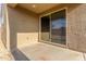 Covered patio features tan stucco walls and sliding glass doors to the backyard at 716 W Blue Ridge Dr, San Tan Valley, AZ 85140